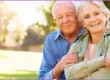 Smiling senior couple outdoors reviewing Medicare Initial Enrollment Period options