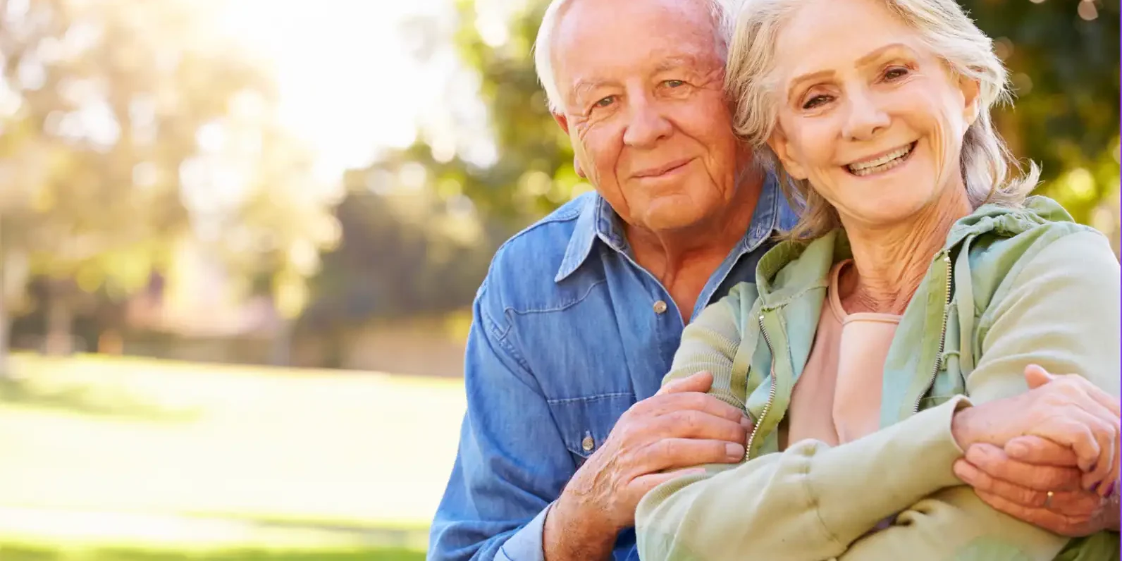 senior-couple-medicare-enrollment-outdoors.webp Smiling senior couple outdoors reviewing Medicare Initial Enrollment Period options