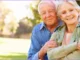 Smiling senior couple outdoors reviewing Medicare Initial Enrollment Period options