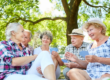 Group of seniors outdoors talking and comparing Medicare coverage options