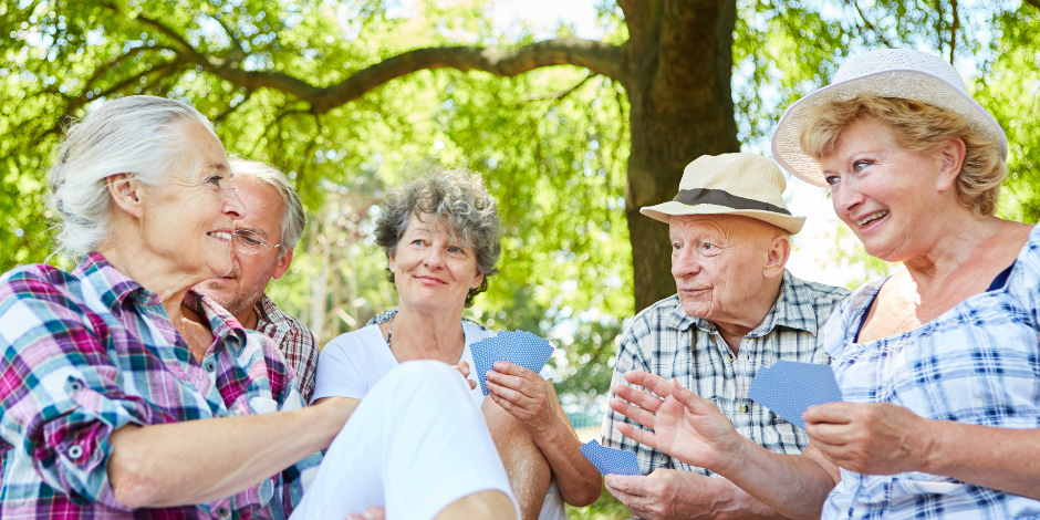 Group of seniors outdoors talking and comparing Medicare coverage options