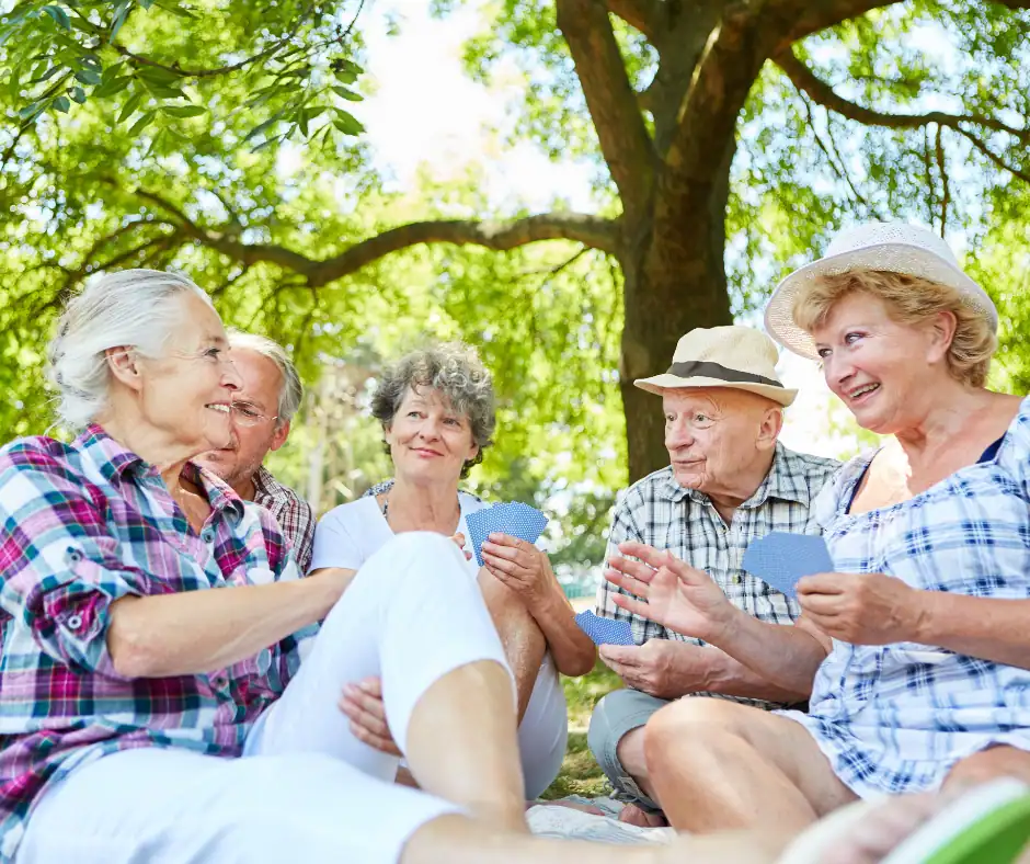 Group of seniors outdoors talking and comparing Medicare coverage options